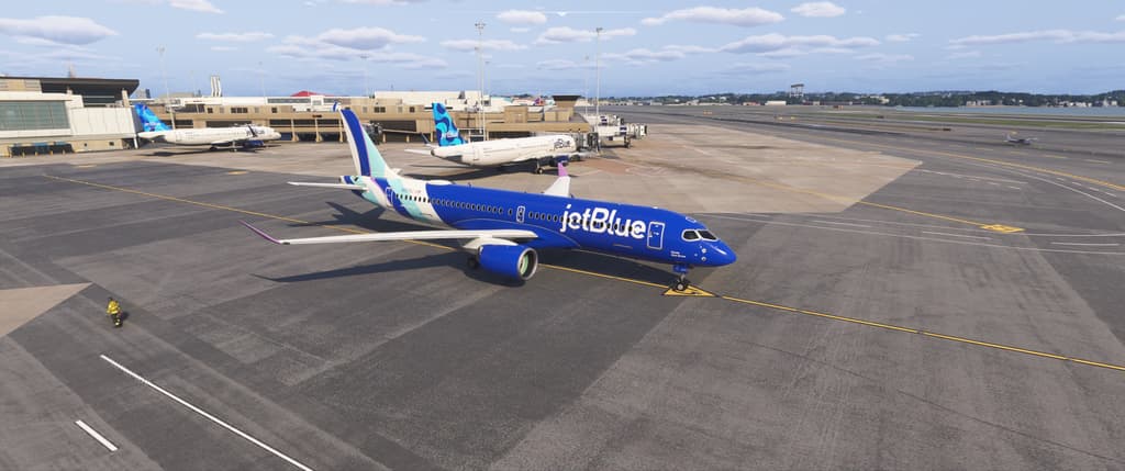 A JetBlue A220-300 in the Hops livery on the ramp at Boston